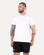 A man wearing a plain white T-shirt and black shorts, standing against a white background.