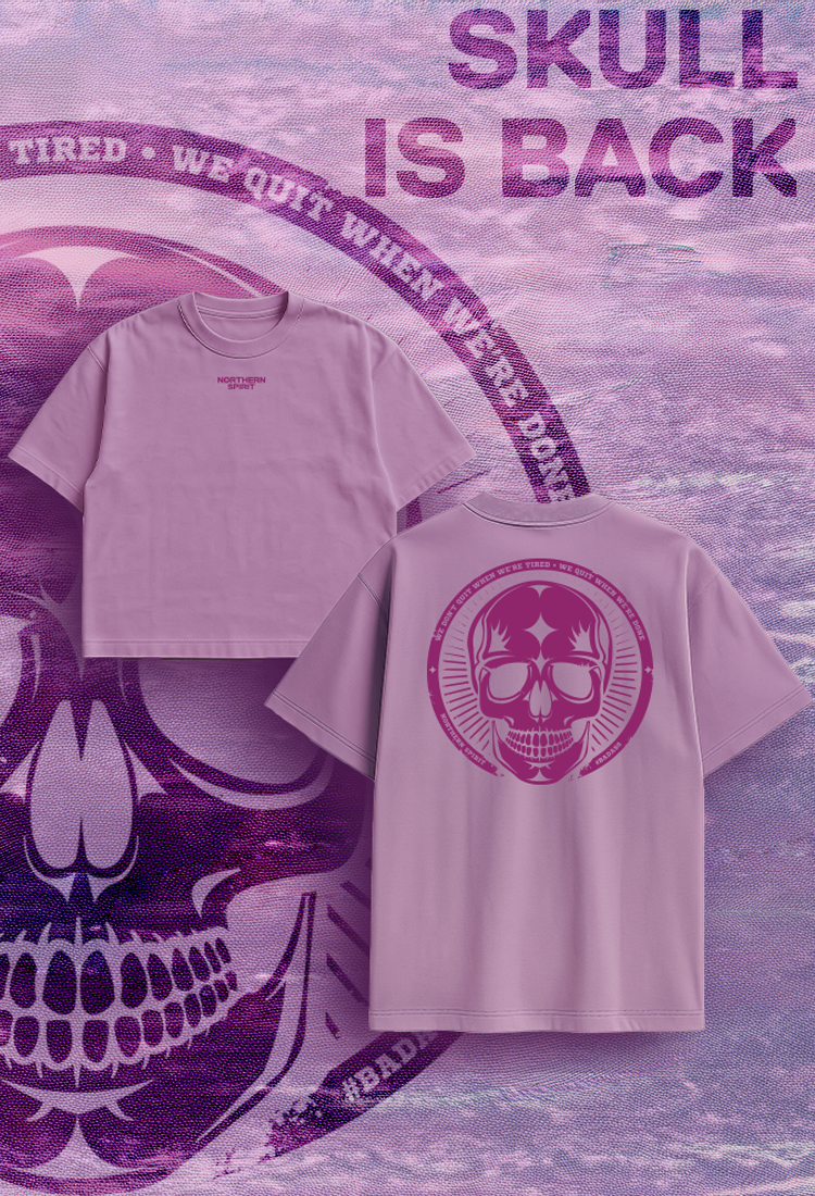 Northern Spirit Skull Collection lavender T-shirts with front logo and bold skull back print displayed on textured purple background.
