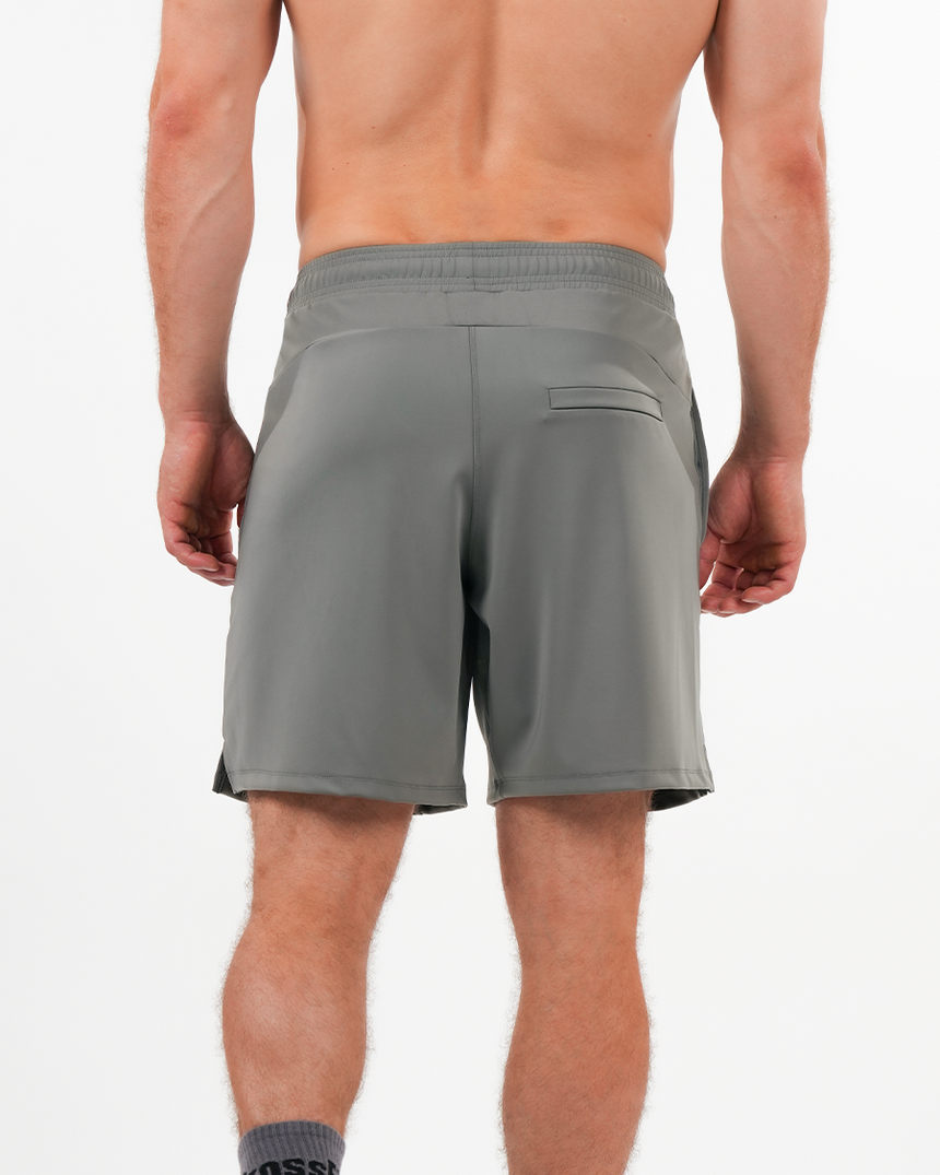 Gray shorts worn by a person on a white background