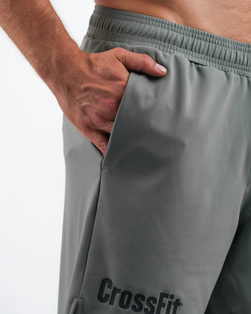 Gray CrossFit shorts with a person wearing them on a white background