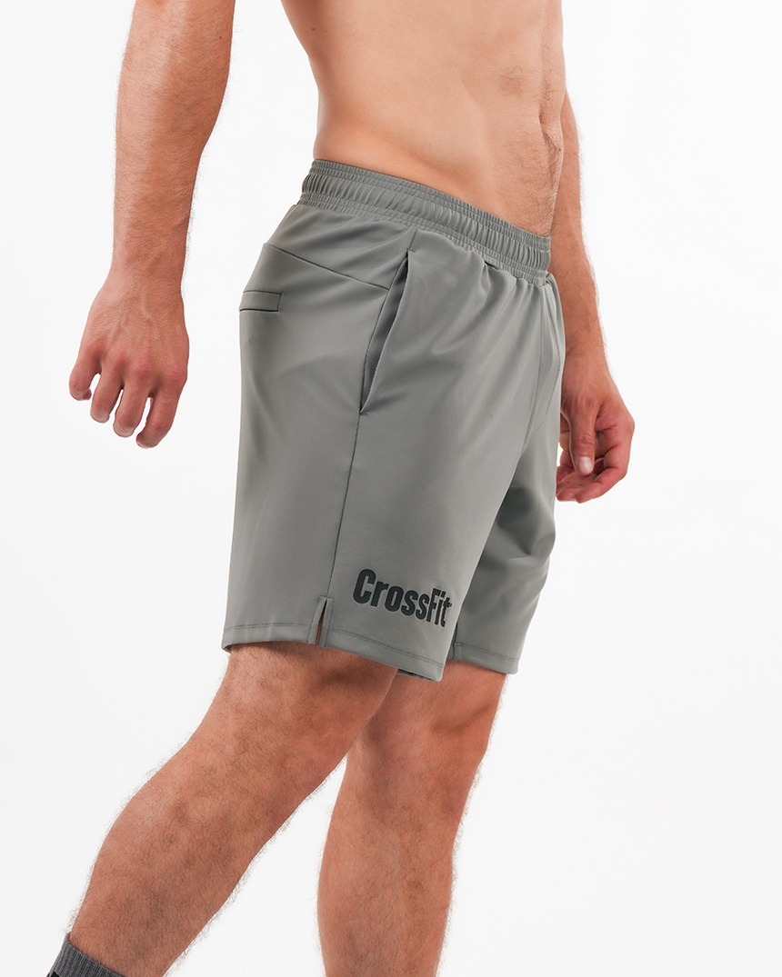 Gray CrossFit shorts worn by a person on a white background