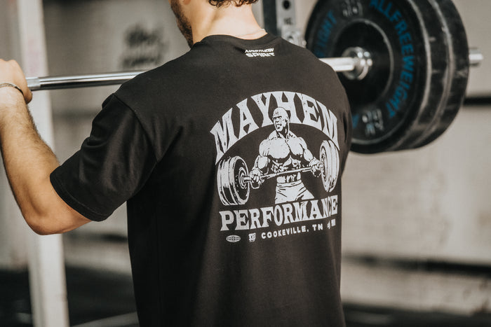 Male athlete lifting weights while wearing a black Mayhem Performance T-shirt — CrossFit apparel by Northern Spirit and Mayhem Athlete.
