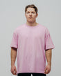 A person wearing a lavender oversized unisex T-shirt.