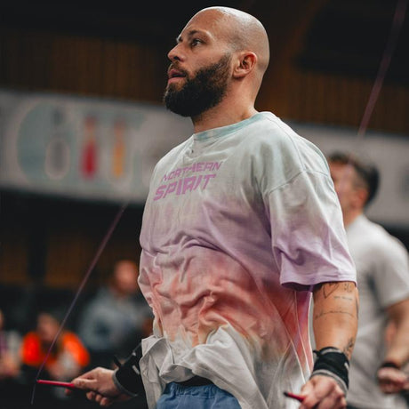 An athlete in full effort doing double unders is dressed in the Prism T-shirt by Northern Spirit.