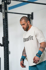 Athlete preparing for training with NS Kraken hand grips secured at the wrist, showing their durable build and comfortable support for high-intensity movements.