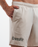 Beige CrossFit shorts worn by a person on a white background