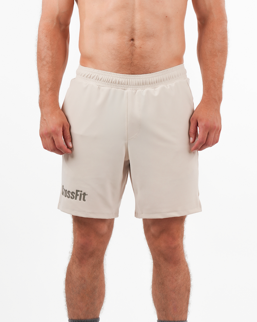Men’s beige CrossFit® 8-inch shorts with tone-on-tone logo, breathable adjustable fit ideal for training.