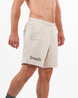 Beige CrossFit shorts worn by a person on a white background