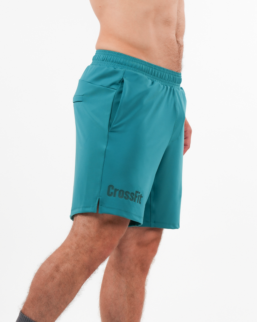 Teal Crossfit shorts worn by a person on a white background
