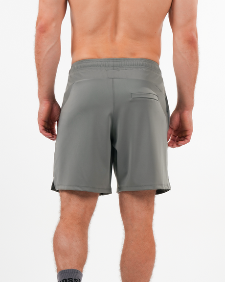 Gray shorts worn by a person on a white background