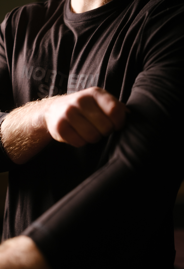 Person wearing a dark shirt with a blurred background