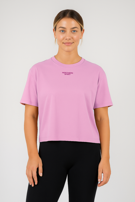 Person wearing a pink t-shirt with a logo on a white background