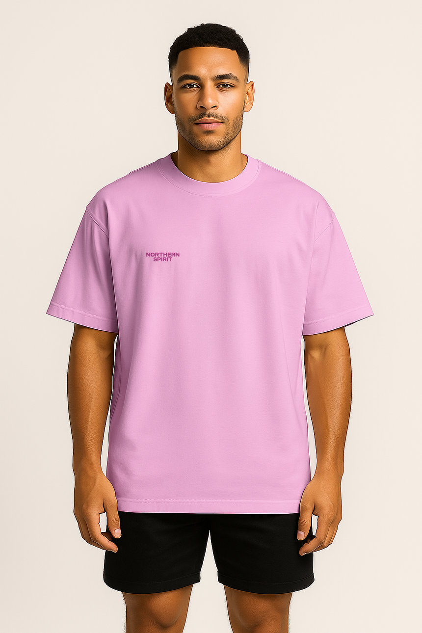 Person wearing a light purple t-shirt with a small logo on a beige background