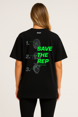 Female model wearing black oversized Save The Rep Algorithm T-shirt, back view with anatomical print and SAVE THE REP green typography.